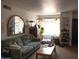 Inviting living room with a couch, wooden table, and lots of plants at 1927 E Hampton Ave # 208, Mesa, AZ 85204
