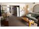 Open living room featuring a comfortable couch, wooden coffee table, and dining area at 1927 E Hampton Ave # 208, Mesa, AZ 85204