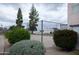 A well-maintained tennis court surrounded by lush greenery, featuring tall trees and vibrant flowering bushes at 1927 E Hampton Ave # 208, Mesa, AZ 85204