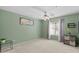 Calming bedroom features soft green walls, a ceiling fan, carpeted floors, and a window with natural light at 2201 N Comanche Dr # 1094, Chandler, AZ 85224