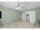 Inviting bedroom featuring light green walls, closet and neutral carpet, illuminated by a ceiling fan at 2201 N Comanche Dr # 1094, Chandler, AZ 85224