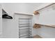Neatly organized walk-in closet with metal shelving and wooden racks, providing ample storage space at 2201 N Comanche Dr # 1094, Chandler, AZ 85224