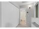 Well-maintained hallway featuring carpeted floors, closet doors, and a view of the bathroom at 2201 N Comanche Dr # 1094, Chandler, AZ 85224