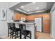 Modern kitchen with wood cabinets, stainless steel appliances, and breakfast bar seating at 2201 N Comanche Dr # 1094, Chandler, AZ 85224