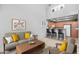 Open-concept living room with a modern kitchen, neutral decor, and breakfast bar seating at 2201 N Comanche Dr # 1094, Chandler, AZ 85224