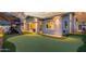 A home's backyard with a playhouse, putting green and a view of the house's exterior at 22858 E Silver Creek Ln, Queen Creek, AZ 85142