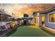 Beautiful backyard with a playground, putting green, and patio seating area, perfect for outdoor entertainment at 22858 E Silver Creek Ln, Queen Creek, AZ 85142