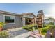 A backyard with a playhouse, patio, rocking horse, and artificial turf at 22858 E Silver Creek Ln, Queen Creek, AZ 85142