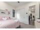 Cozy bedroom with plush pink bedding, decorative shelves, and access to the hallway at 22858 E Silver Creek Ln, Queen Creek, AZ 85142