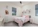 A bright bedroom features a plush pink bed, colorful decor, and large windows at 22858 E Silver Creek Ln, Queen Creek, AZ 85142