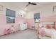 Bright and colorful bedroom with a four-poster bed, vanity, and pink accents at 22858 E Silver Creek Ln, Queen Creek, AZ 85142