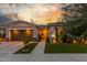 Inviting single-story home featuring a manicured lawn, landscape lighting, and an attached two-car garage at 22858 E Silver Creek Ln, Queen Creek, AZ 85142