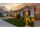 Attractive one-story home with a manicured lawn, garden, landscape lighting, and a two-car garage at 22858 E Silver Creek Ln, Queen Creek, AZ 85142