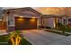 Lovely single-story home with a well-maintained lawn, landscape lighting, and a spacious two-car garage at 22858 E Silver Creek Ln, Queen Creek, AZ 85142