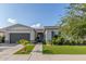 Charming one-story home featuring lush front lawn, mature trees, and an attached two-car garage at 22858 E Silver Creek Ln, Queen Creek, AZ 85142