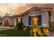 Charming single-story home with a well-manicured lawn and landscape lighting for evening enjoyment at 22858 E Silver Creek Ln, Queen Creek, AZ 85142