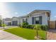 Charming single-story home featuring a landscaped front yard with artificial turf and a gray stucco exterior at 22858 E Silver Creek Ln, Queen Creek, AZ 85142