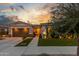 Beautiful one-story home with manicured lawn, mature trees and landscape lighting, creating a warm ambiance at 22858 E Silver Creek Ln, Queen Creek, AZ 85142