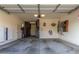 Spacious three-car garage featuring extensive storage and Tesla Powerwall setup at 22858 E Silver Creek Ln, Queen Creek, AZ 85142