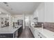 Bright kitchen features white cabinetry, stainless steel appliances, sleek countertops, and a large kitchen island at 22858 E Silver Creek Ln, Queen Creek, AZ 85142
