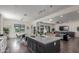 A bright kitchen looks into the modern living room with a couch, TV, and backyard access through sliding doors at 22858 E Silver Creek Ln, Queen Creek, AZ 85142