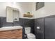 Stylish powder room features sleek fixtures, modern vanity, and elegant black wainscoting at 22858 E Silver Creek Ln, Queen Creek, AZ 85142