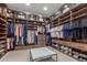 Spacious walk-in closet with custom shelving, drawers, and ample storage space at 22858 E Silver Creek Ln, Queen Creek, AZ 85142