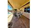 This covered patio features outdoor seating, a ceiling fan, and a glimpse of the sparkling pool at 23833 N 39Th N Ln, Glendale, AZ 85310
