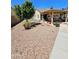 Enjoy this backyard area featuring decorative rock landscaping, covered patio, and potted plants at 23833 N 39Th N Ln, Glendale, AZ 85310