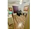 Well-lit home office featuring wood-look floors, a ceiling fan, and a neatly organized desk at 23833 N 39Th N Ln, Glendale, AZ 85310