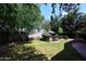Expansive backyard with lush grass, trees, and outdoor seating, perfect for relaxation at 2413 S 121St Dr, Avondale, AZ 85323