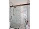 Modern bathroom with stylish tilework, a frameless glass shower door, and sleek fixtures at 2413 S 121St Dr, Avondale, AZ 85323
