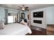 Bedroom with a fireplace, television, and view to the outside at 2413 S 121St Dr, Avondale, AZ 85323