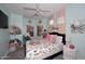 A colorful bedroom with a ceiling fan, plush carpet, and ample natural light from large windows at 2413 S 121St Dr, Avondale, AZ 85323