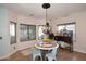 Cozy breakfast nook with a round table, decorative chandelier, and bright natural light streaming through the windows at 2413 S 121St Dr, Avondale, AZ 85323