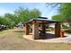 Community park with a shaded picnic area and seating, perfect for outdoor gatherings at 2413 S 121St Dr, Avondale, AZ 85323