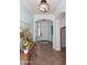Bright foyer with tile flooring, arched doorways, elegant lighting, and a decorative console table at 2413 S 121St Dr, Avondale, AZ 85323