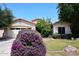 Charming single-story home featuring a two-car garage, lush landscaping, and desert plants at 2413 S 121St Dr, Avondale, AZ 85323