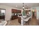 Well-lit kitchen with a granite-topped island, pendant lights, and stainless-steel appliances at 2413 S 121St Dr, Avondale, AZ 85323