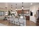 Modern kitchen with pendant lighting, granite countertops, and bar seating, seamlessly connected to living area at 2413 S 121St Dr, Avondale, AZ 85323