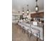 An open kitchen with a granite countertop island and gorgeous lighting fixture over the breakfast bar at 2413 S 121St Dr, Avondale, AZ 85323