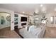 Open-concept living room with a cozy sectional sofa, built-in shelves, and an inviting fireplace at 2413 S 121St Dr, Avondale, AZ 85323
