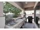 Outdoor kitchen with stone facade and a built-in barbeque at 2413 S 121St Dr, Avondale, AZ 85323