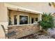 Outdoor covered patio featuring a stone bar, seating, and views of the backyard at 2413 S 121St Dr, Avondale, AZ 85323