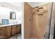 This remodeled bathroom features a new shower and a vanity with double sinks at 2524 E Elmwood St, Mesa, AZ 85213