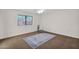 Bright bedroom featuring a large window, ceiling fan, and area rug at 2524 E Elmwood St, Mesa, AZ 85213