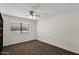 Bedroom with ceiling fan, large window for natural light and neutral carpet at 2524 E Elmwood St, Mesa, AZ 85213