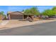 Single-story home boasts a spacious driveway, attached two-car garage, and desert landscaping at 2524 E Elmwood St, Mesa, AZ 85213