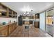 Bright kitchen featuring tile flooring, stainless steel fridge, and wood cabinets at 2524 E Elmwood St, Mesa, AZ 85213