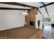 Spacious living room with exposed ceiling beams, a brick fireplace, and tiled entryway at 2524 E Elmwood St, Mesa, AZ 85213